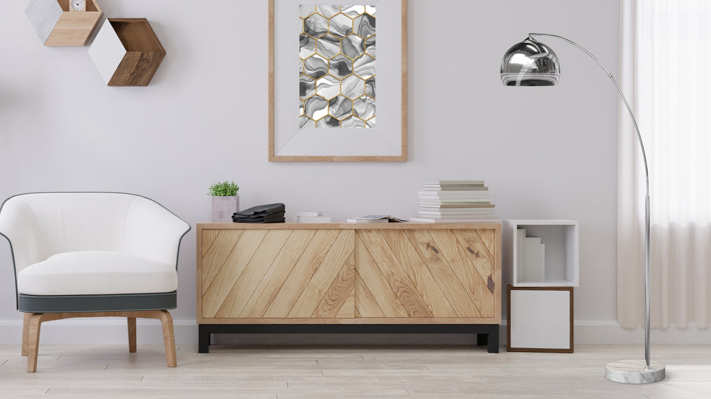 Teamson silver floor lamp is in the corner next to a wooden sideboard and modern white chair.